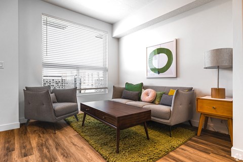 a living room with a couch and two chairs